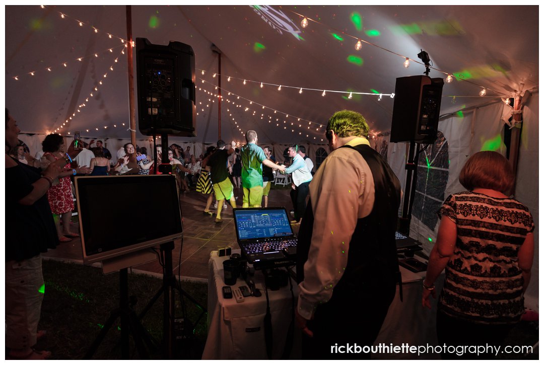 behind the scenes of dj with guests dancing at New Hampshire backyard summer wedding reception