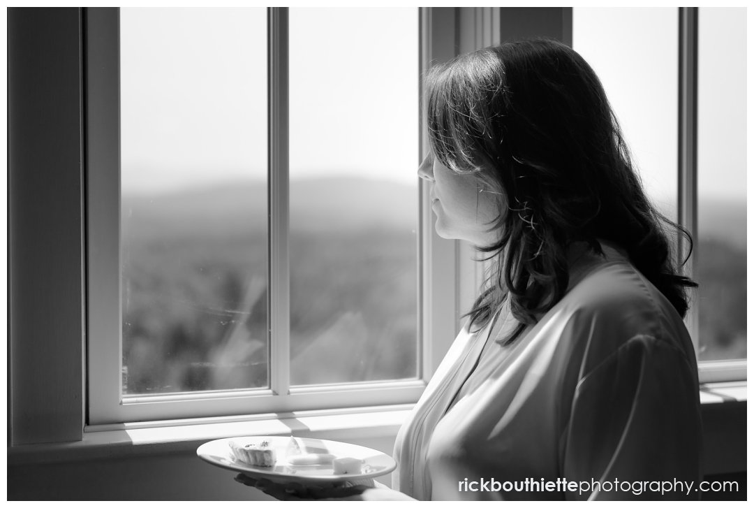 bride looking out window to ceremony site at Mountain View Grand wedding