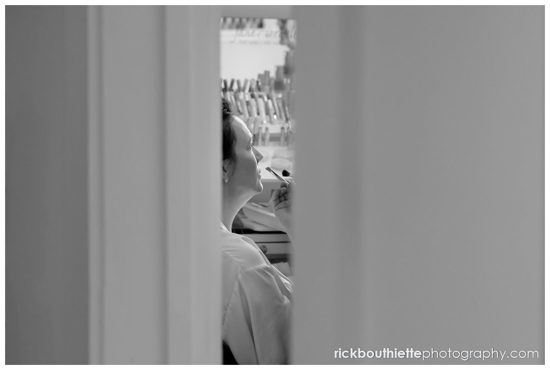 peeking in at bride having makeup done at Mountain View Grand wedding