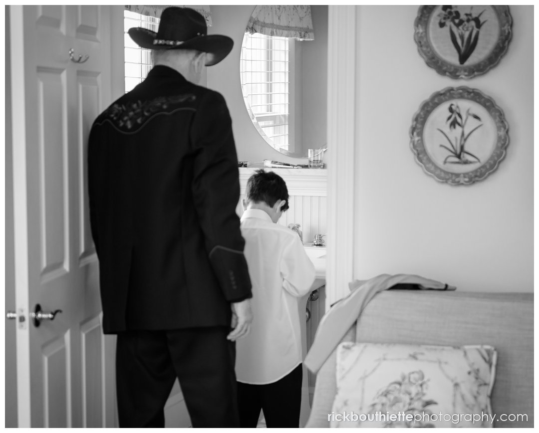 grandfather helps his grandson get ready for parent's Mountain View Grand wedding