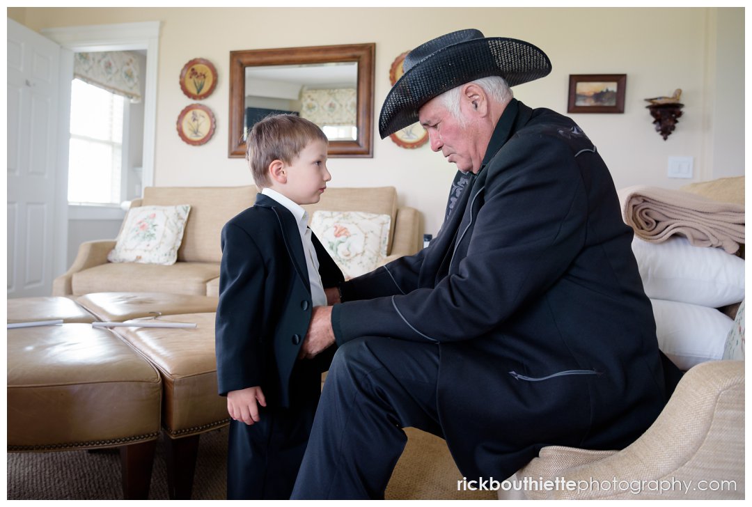 grandfather helps his grandson get ready for parent's Mountain View Grand wedding