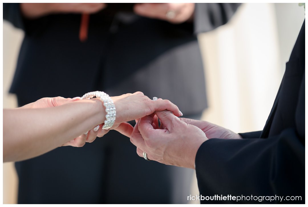 bride and groom exchange rings at Mountain view Grand wedding ceremony