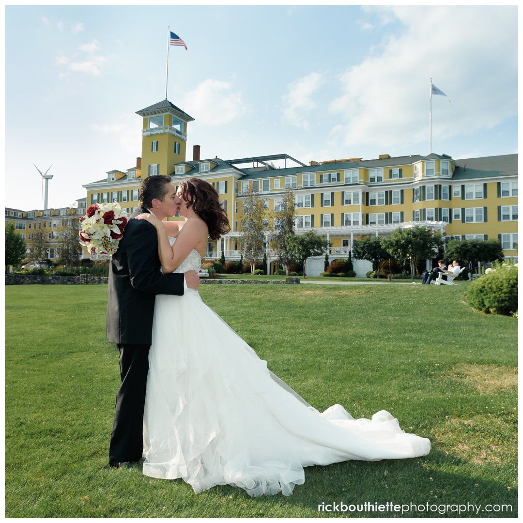 bride and groom kiss with Mountain View Grand Resort in background