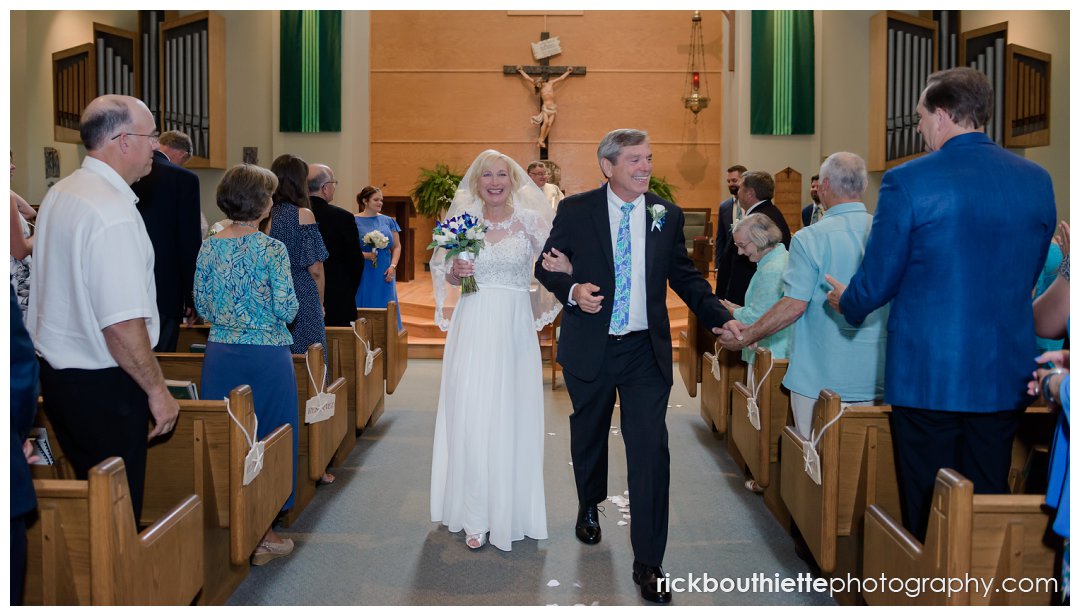 bride and groom walking down aisle after wedding ceremony at Saint Joseph's Parish
