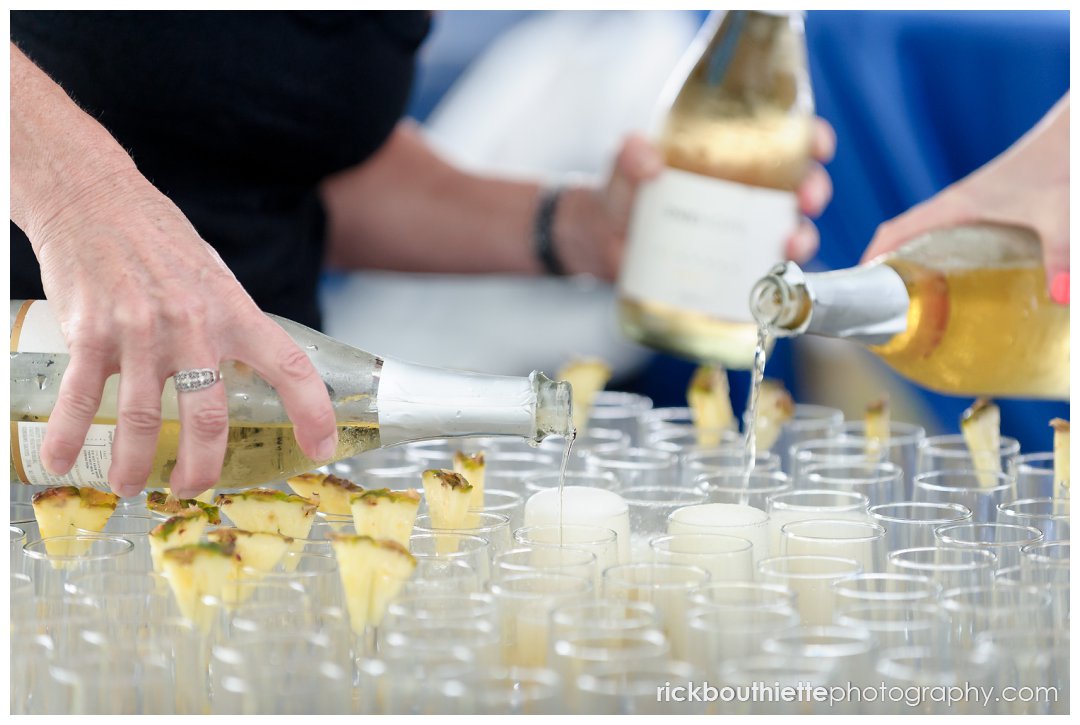 filling toast glasses at scenic ocean view at Ordiorne Point Seacoast wedding