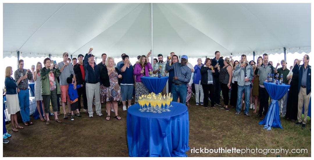 guest toast the bride and groom at Ordiorne Point Seacoast wedding