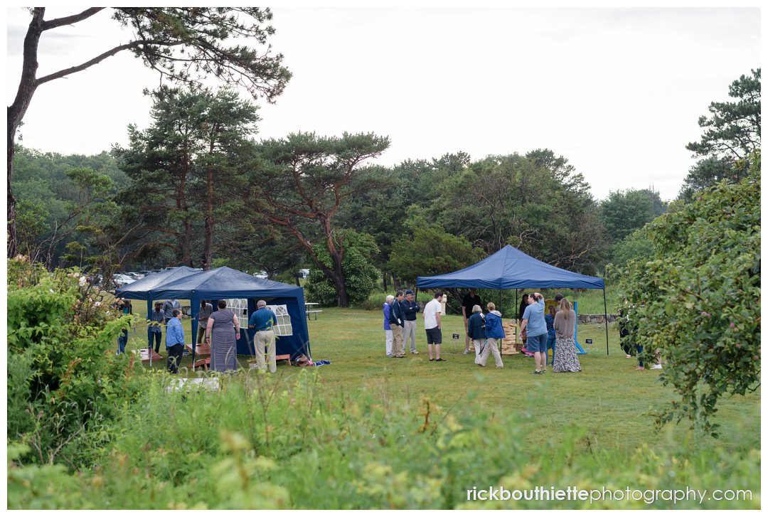 overall view of guests playing lawn games at Ordiorne Point Seacoast wedding reception 