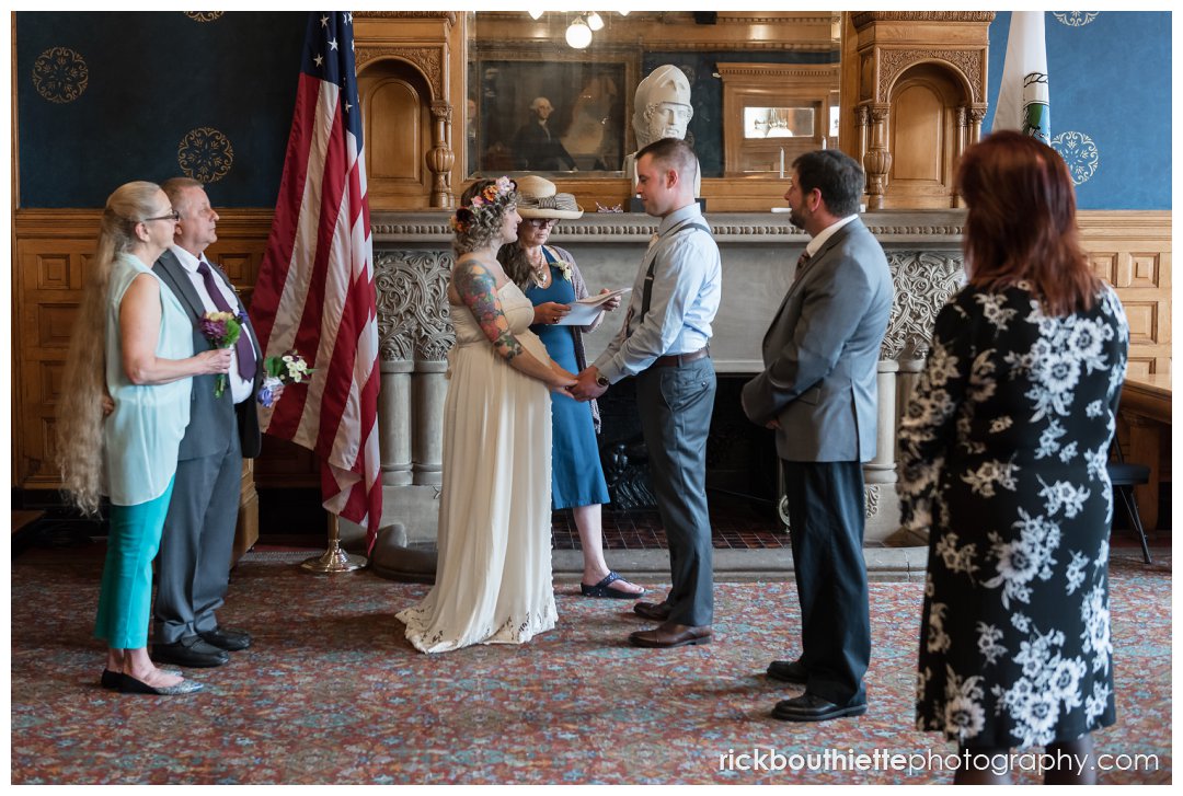 bride & groom exchange vows at lowell city hall wedding