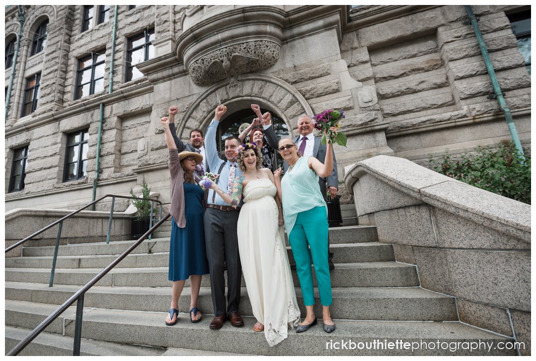 bride groom & family celebrate in front of lowell city hall after wedding