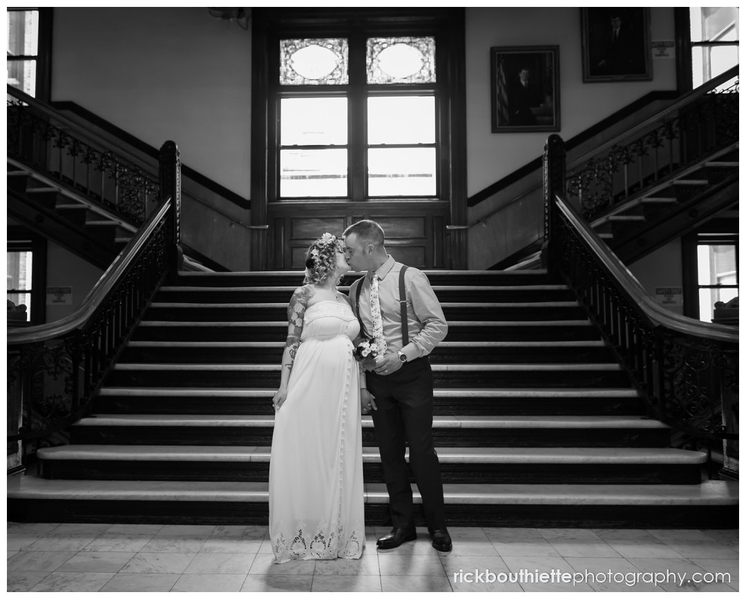 bride & groom kiss on stairs after lowell city hall wedding