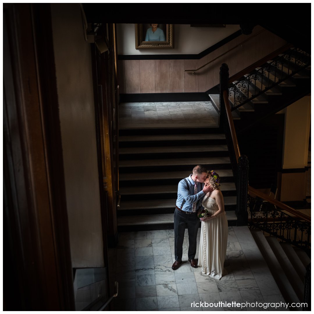 bride & groom on stairs after lowell city hall wedding ceremony