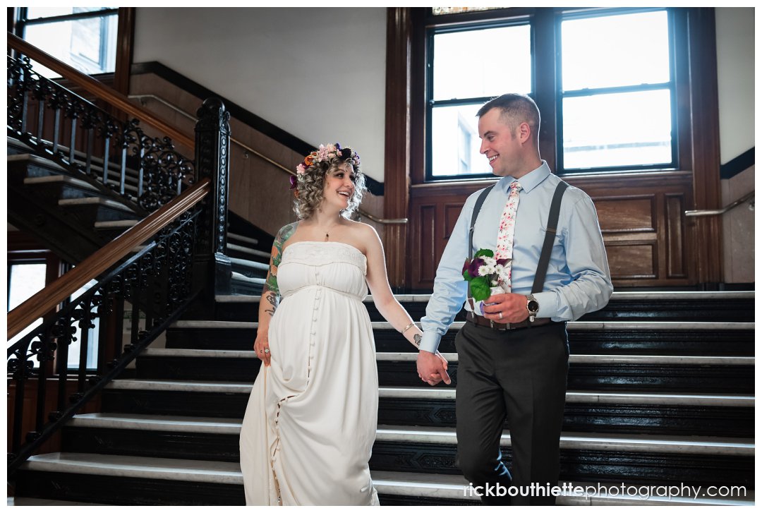bride & groom walking down stairs after lowell city hall wedding ceremony