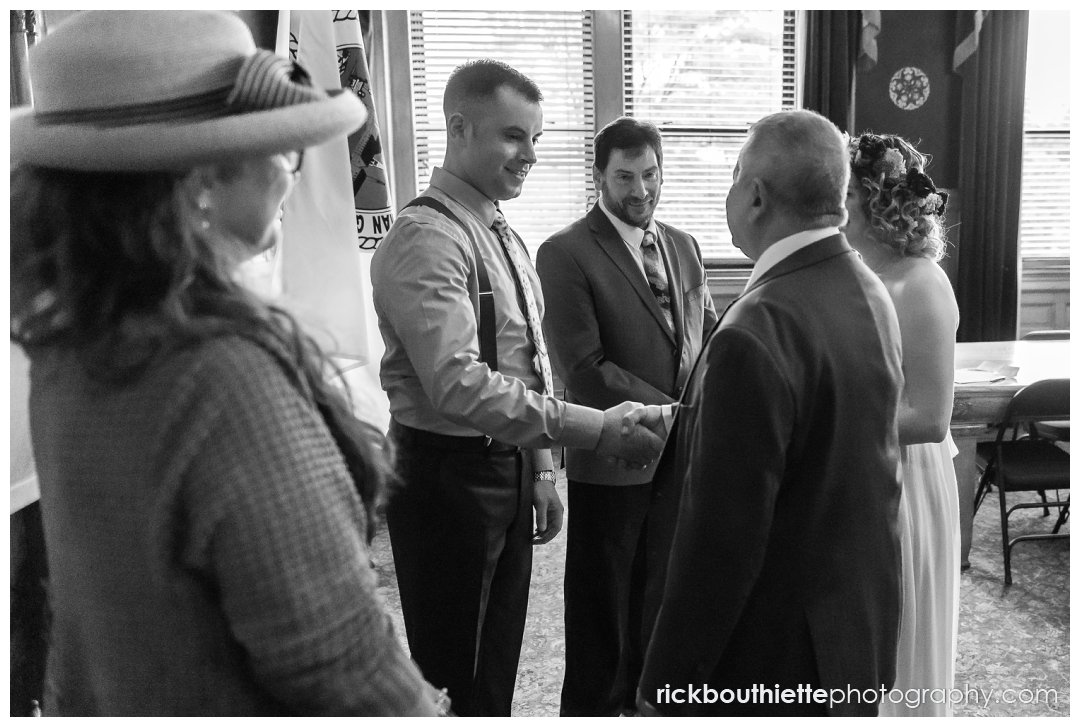 father of bride shaking grooms hand lowell city hall wedding