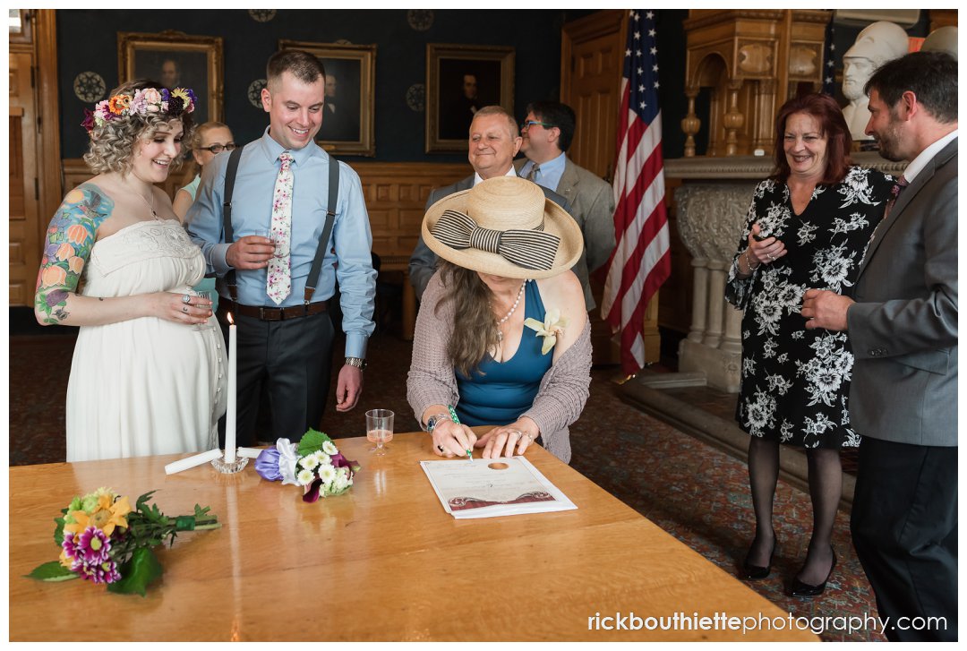 signing documents at lowell city hall wedding ceremony