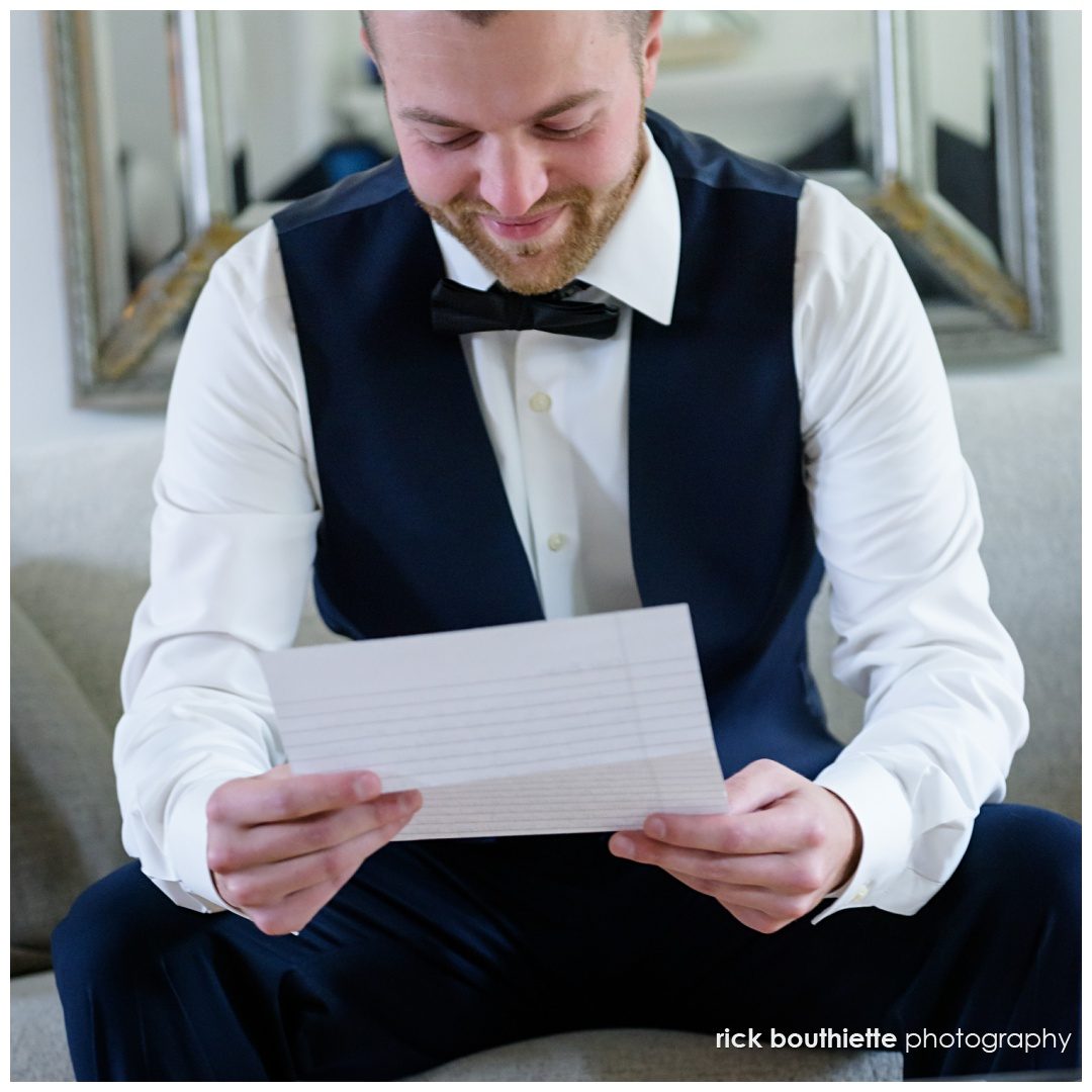 groom reading letter from his bride to be at The Thompson Inn